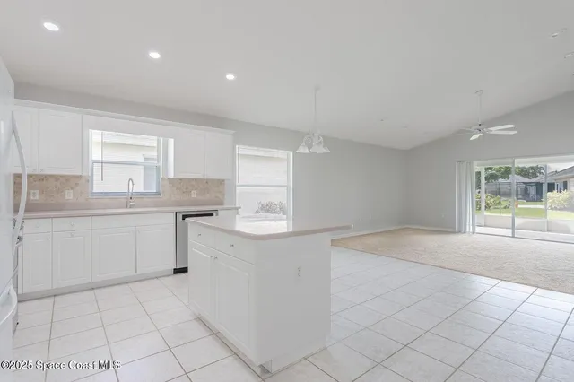 a kitchen with a sink cabinets and window
