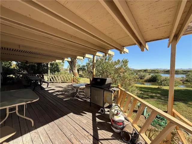 a view of a balcony with chairs and wooden floor