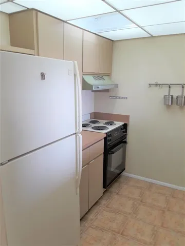 a kitchen with a stove and a refrigerator