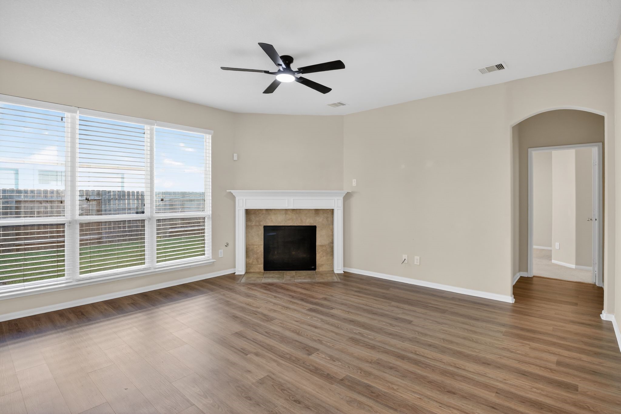 4938 Yearling Ridge Court Katy, TX 77449 - Photo 5 of 29 an empty room with wooden floor fan and windows
