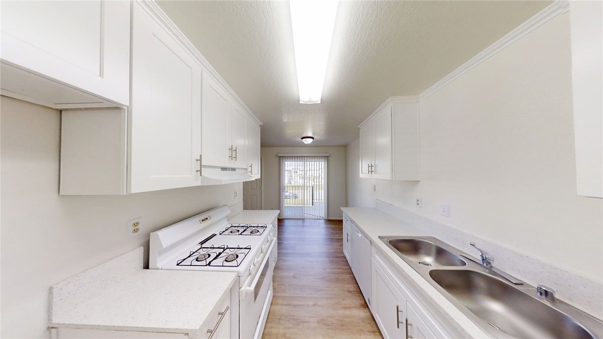 13475 4th Street, Unit 5 Yucaipa, CA 92399 - Photo 5 of 10 a kitchen with a sink a stove and cabinets