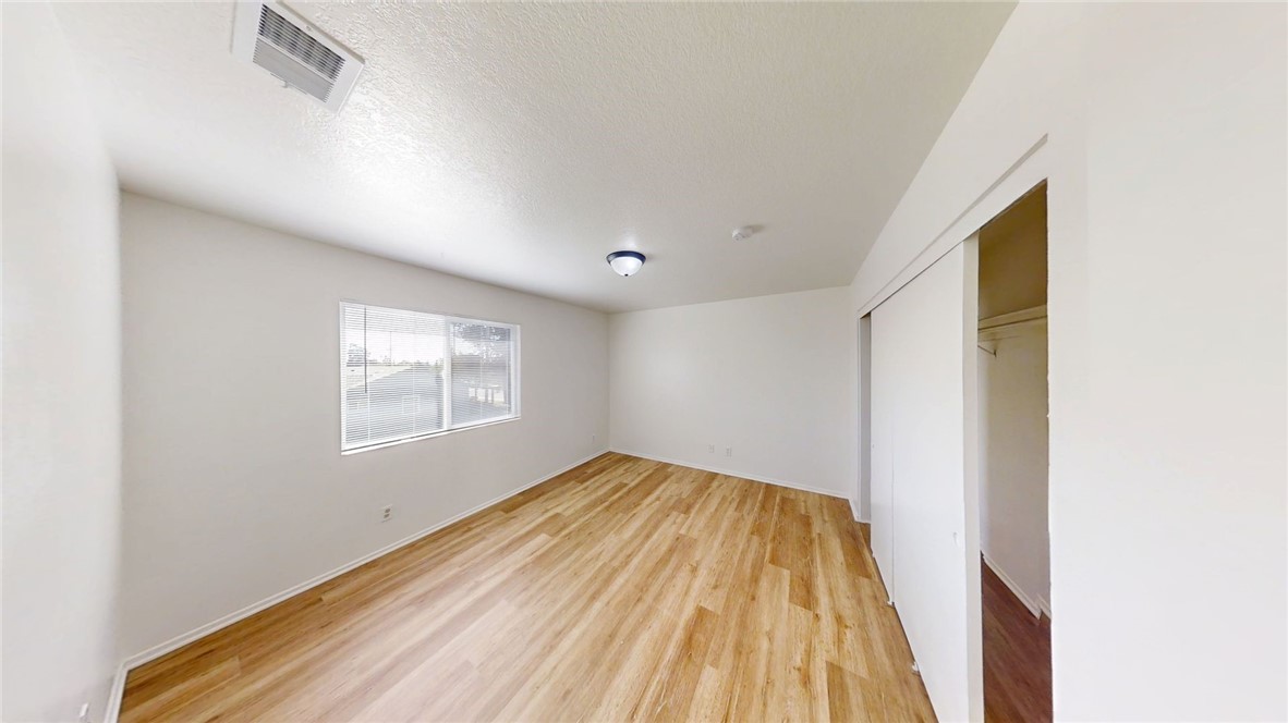 13475 4th Street, Unit 5 Yucaipa, CA 92399 - Photo 7 of 10 a view of a room with wooden floor and a window