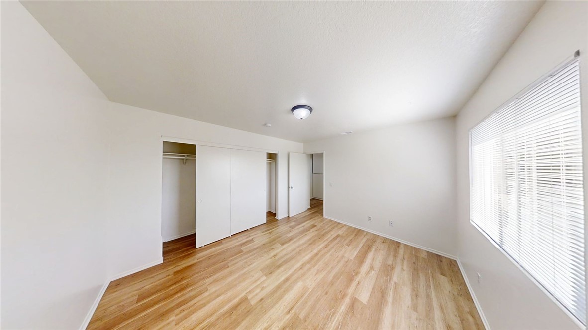 13475 4th Street, Unit 5 Yucaipa, CA 92399 - Photo 8 of 10 a view of empty room with wooden floor and fan