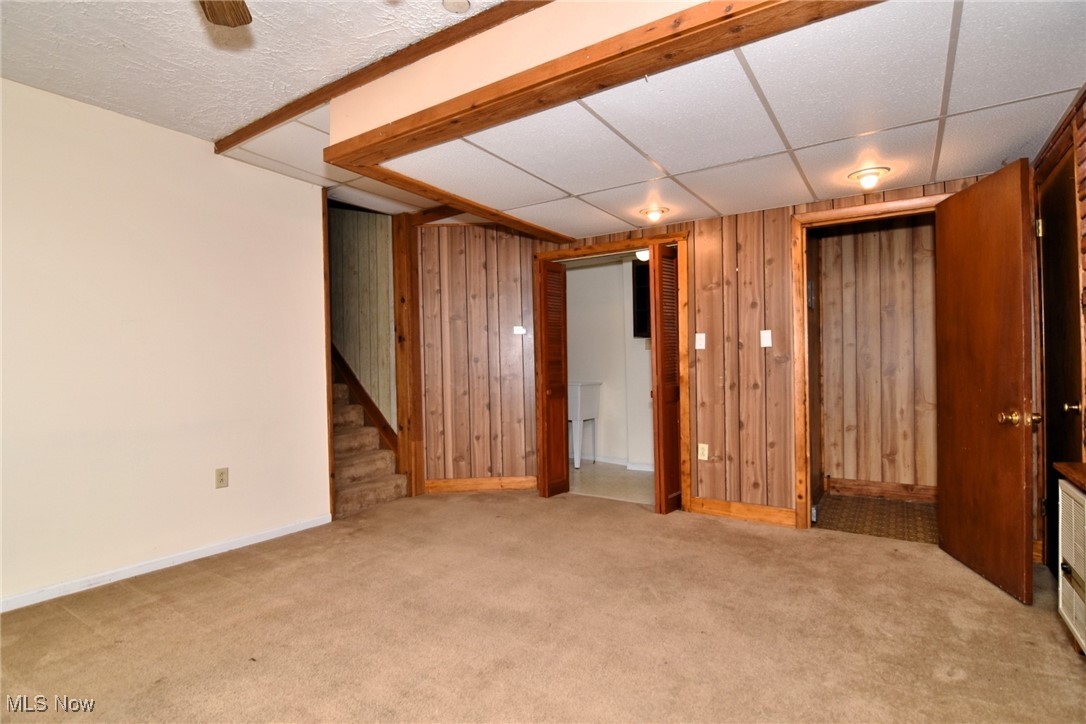 14405 Madison Road Middlefield, OH 44062 - Photo 12 of 30 Finished below grade area featuring carpet flooring, stairs, and wooden walls