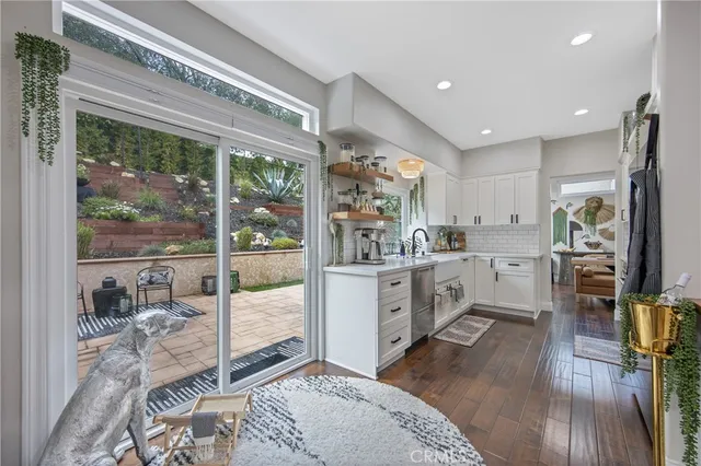 a kitchen with sink refrigerator and large window