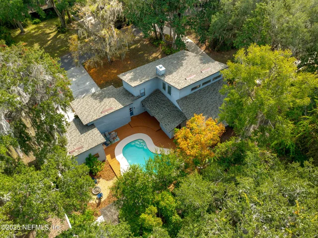 an aerial view of a house with swimming pool and outdoor space