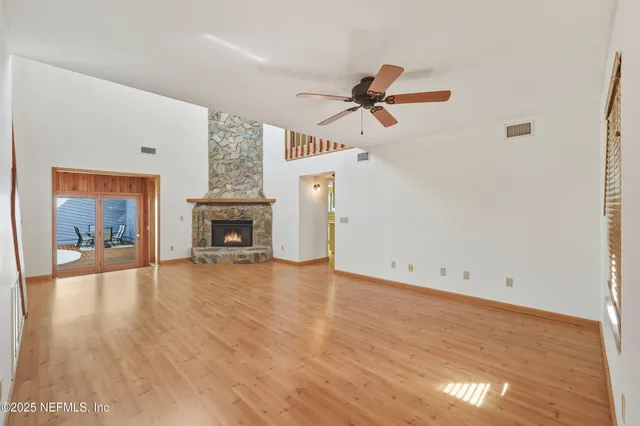 wooden floor in an empty room with a fireplace