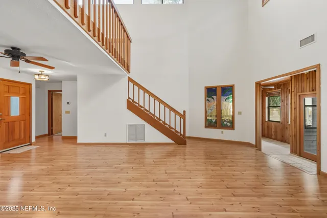 a view of an entryway wooden floor and windows