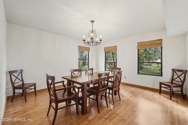 a view of a dining room with furniture and windows