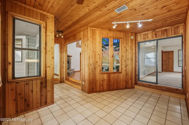a view of a hallway with wooden walls