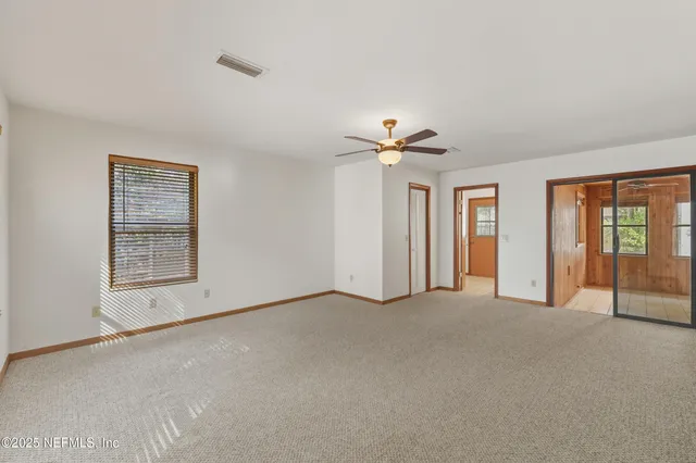 a view of an empty room with closet area