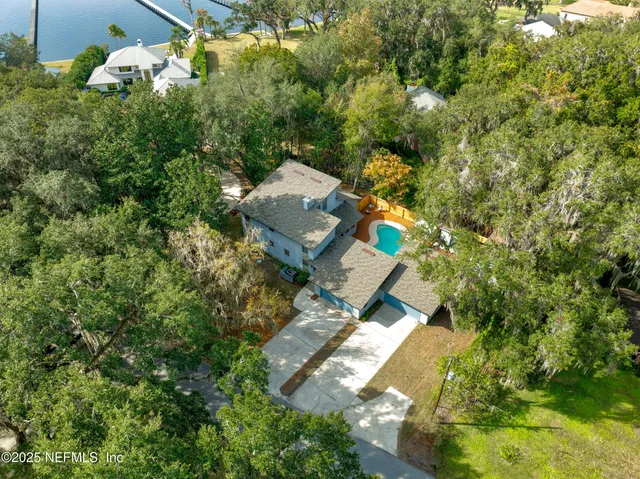 an aerial view of a house with yard swimming pool and outdoor seating