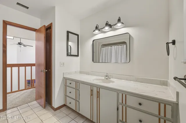 a bathroom with a double vanity sink and a mirror
