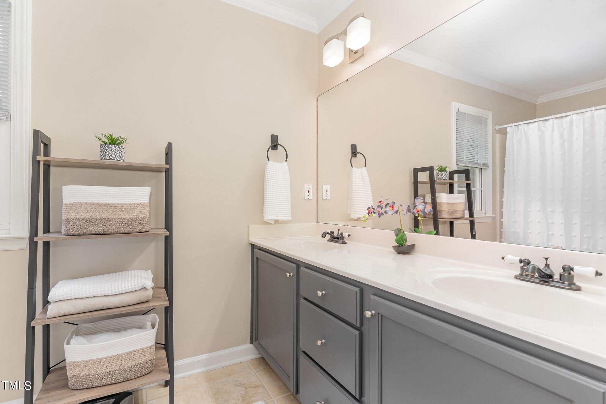 3224 Terrel Mill Road Raleigh, NC 27616 - Photo 12 of 21 a bathroom with a double vanity sink and a mirror