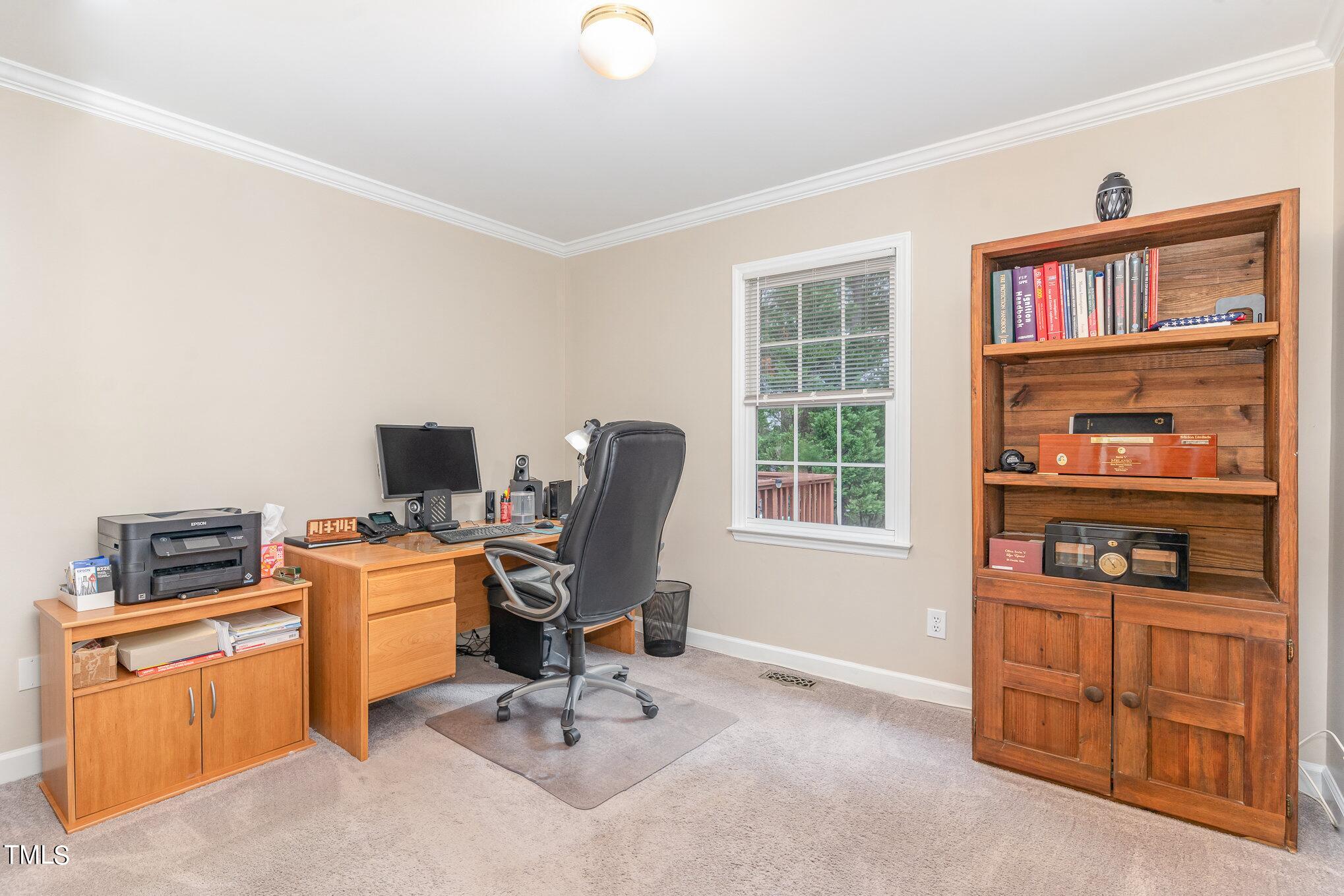 3224 Terrel Mill Road Raleigh, NC 27616 - Photo 14 of 21 a view of a workspace with furniture and a window