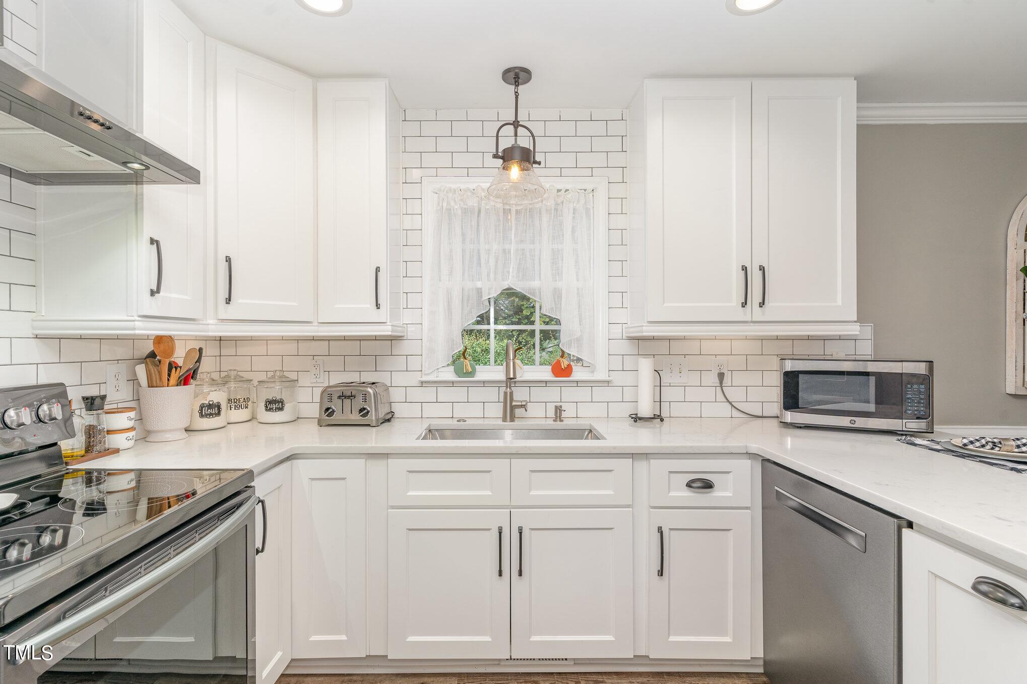 3224 Terrel Mill Road Raleigh, NC 27616 - Photo 7 of 21 a kitchen with white cabinets and white appliances