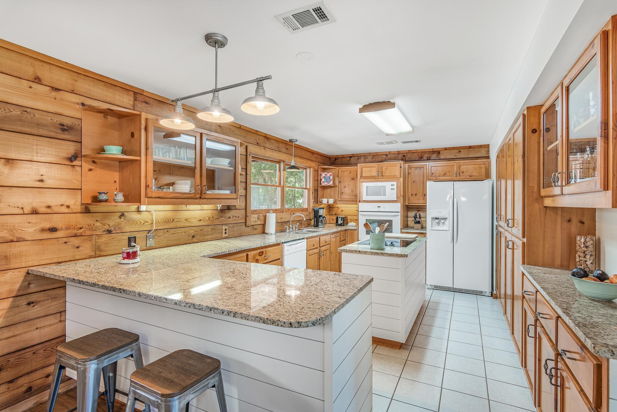 279 Pinewood Lane Inlet Beach, FL 32461 - Photo 17 of 48 a kitchen with stainless steel appliances granite countertop a sink and cabinets