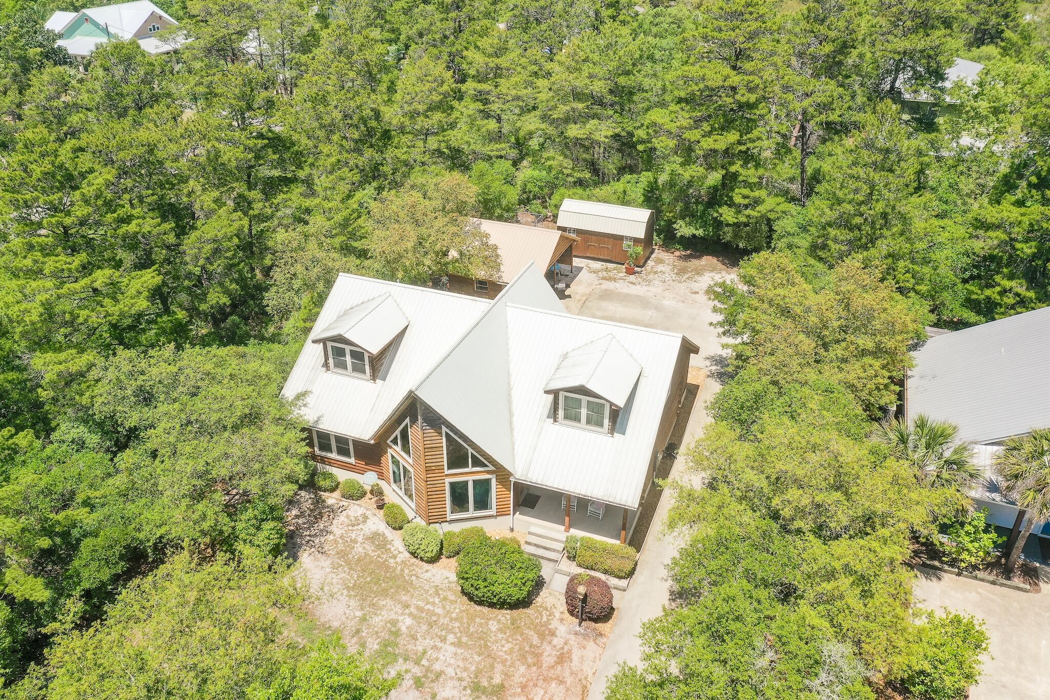 279 Pinewood Lane Inlet Beach, FL 32461 - Photo 2 of 48 a view of a house with a yard and sitting area
