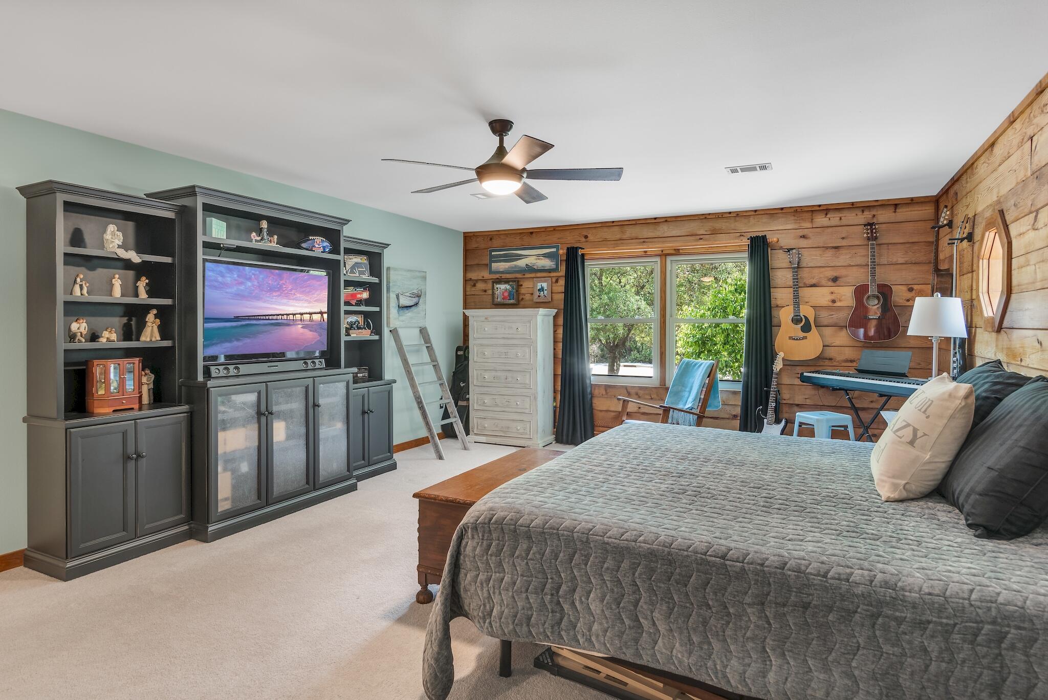 279 Pinewood Lane Inlet Beach, FL 32461 - Photo 21 of 48 a bedroom with a large bed and a flat tv screen
