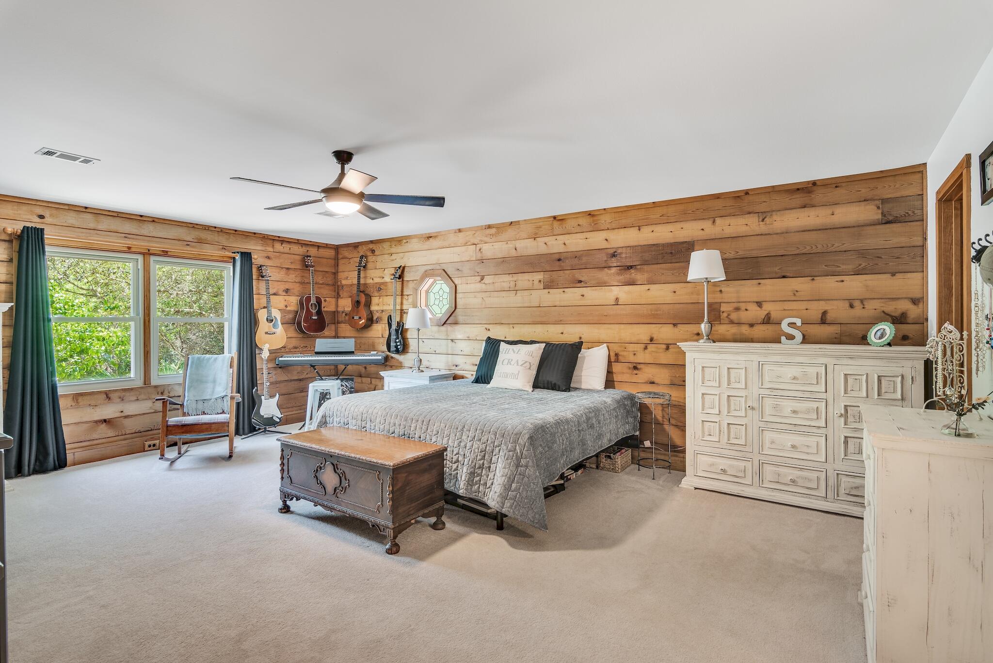 279 Pinewood Lane Inlet Beach, FL 32461 - Photo 22 of 48 a spacious bedroom with a bed and ceiling fan