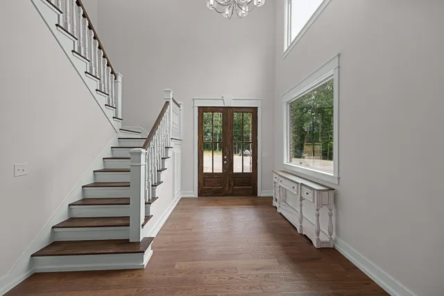 a view of entryway with wooden floor and stairs