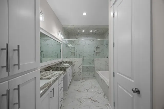 a bathroom with a bathtub and shower