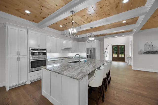 a kitchen with stainless steel appliances granite countertop a stove and a refrigerator