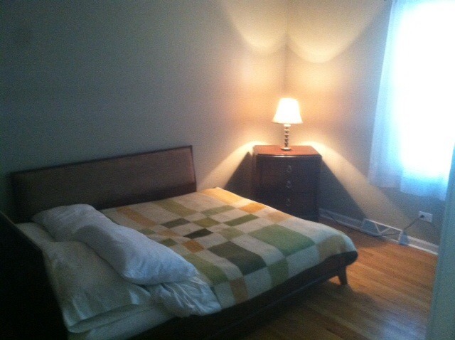 914 East Irving Park Road Itasca, IL 60143 - Photo 13 of 21 a bedroom with a bed and a lamp