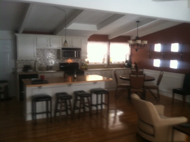 914 East Irving Park Road Itasca, IL 60143 - Photo 6 of 21 a kitchen with stainless steel appliances a dining table chairs and a wooden floor