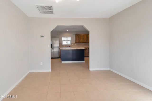 an empty room with a fireplace and windows