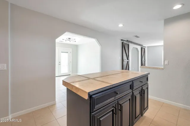 a room that has a sink and a large mirror in it