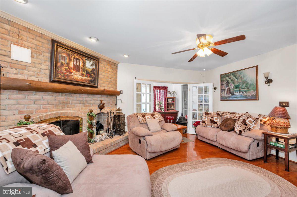 4810 Reyburn Court North Mount Airy, MD 21771 - Photo 17 of 61 a living room with furniture a fireplace and a flat screen tv