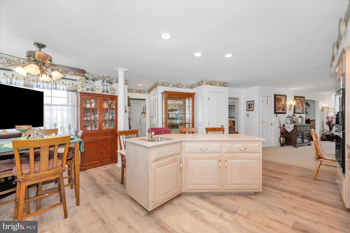 4810 Reyburn Court North Mount Airy, MD 21771 - Photo 25 of 61 a large white kitchen with a large island in the center and stainless steel appliances