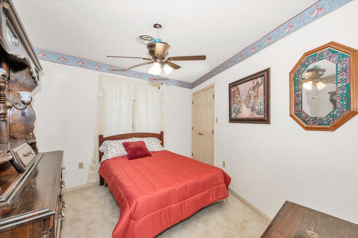 4810 Reyburn Court North Mount Airy, MD 21771 - Photo 44 of 61 a bedroom with a bed and a chandelier