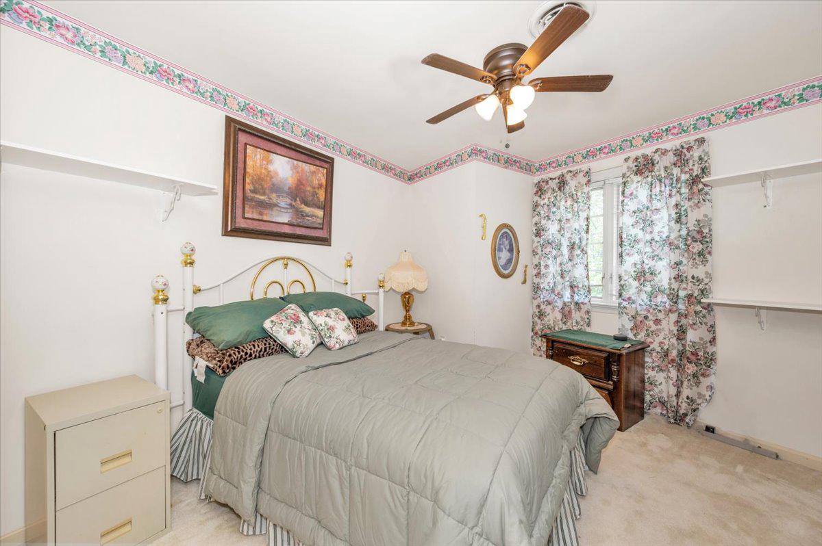 4810 Reyburn Court North Mount Airy, MD 21771 - Photo 46 of 61 a bedroom with a bed and a chandelier