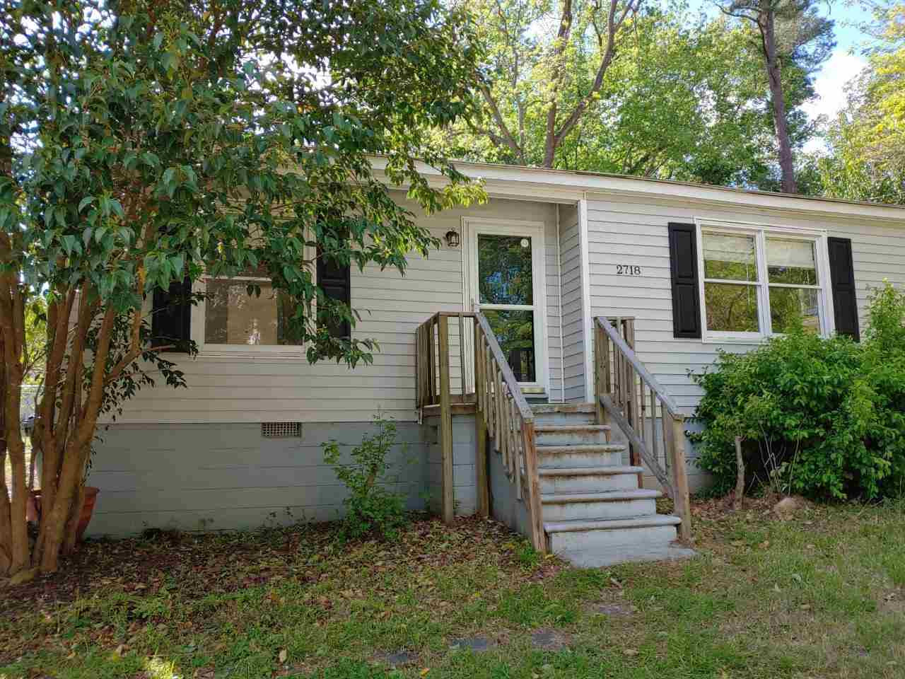 2718 Newbold Street Raleigh, NC 27603 - Photo 1 of 7 front view of a house with a yard