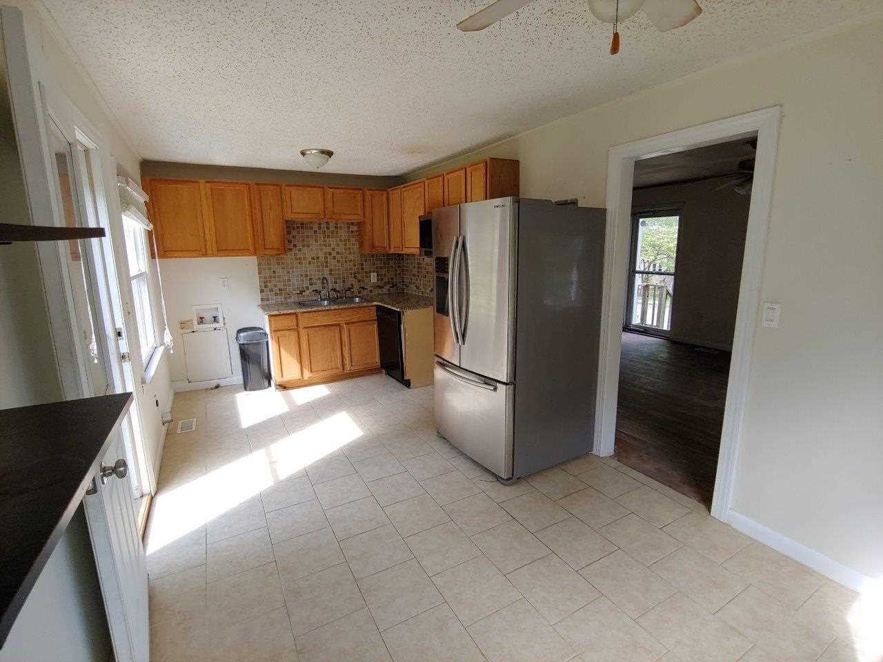 2718 Newbold Street Raleigh, NC 27603 - Photo 2 of 7 a kitchen with a refrigerator and a stove