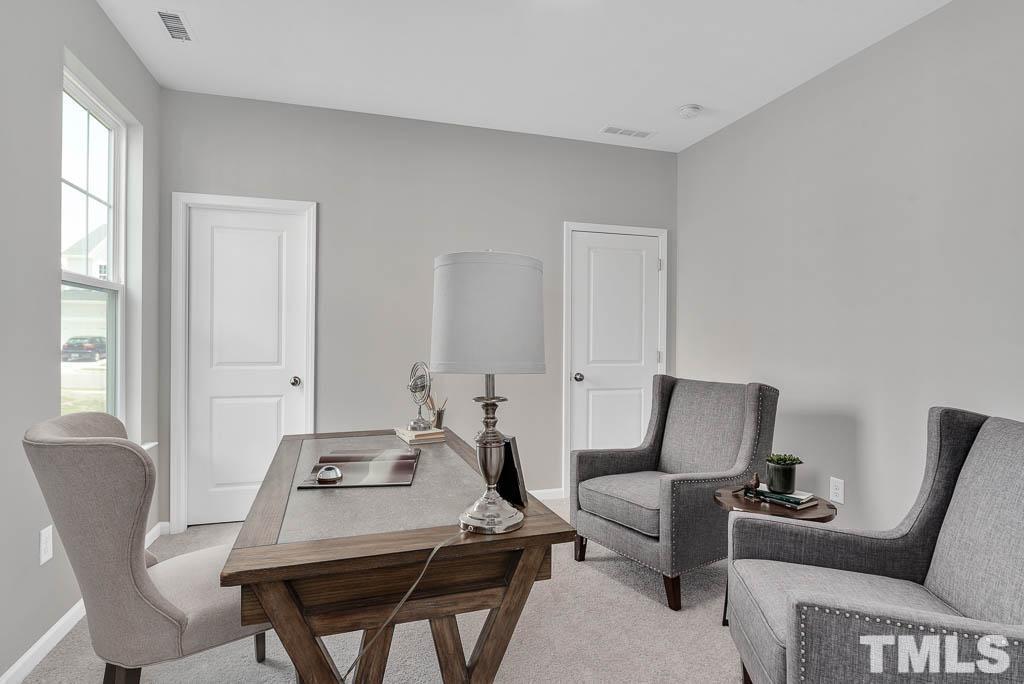 112 Thrower Lane Garner, NC 27529 - Photo 18 of 38 a living room with furniture and a window