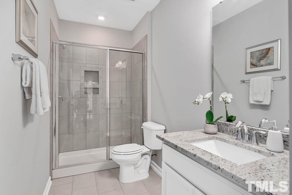 112 Thrower Lane Garner, NC 27529 - Photo 19 of 38 a bathroom with a granite countertop sink a toilet and shower