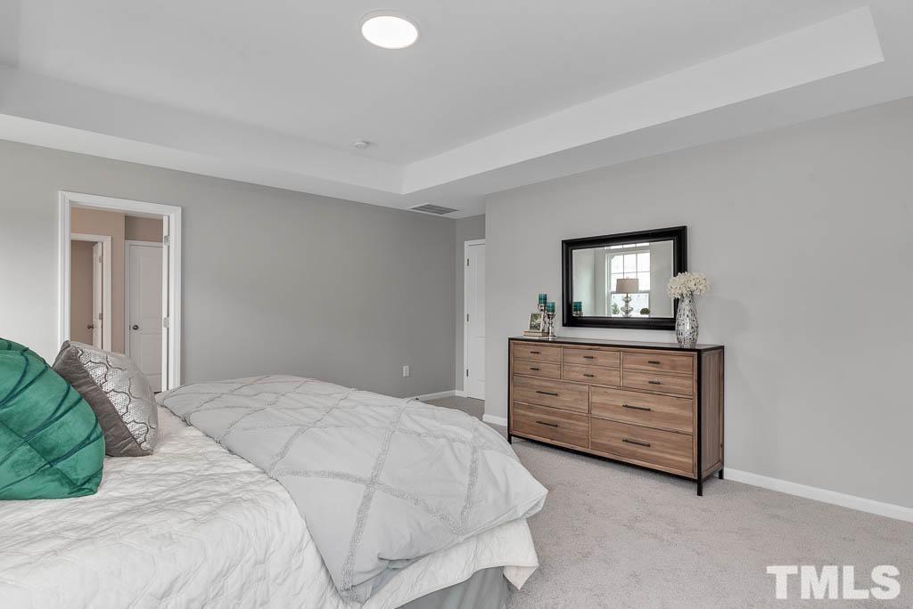 112 Thrower Lane Garner, NC 27529 - Photo 23 of 38 a bedroom with a bed and a dresser