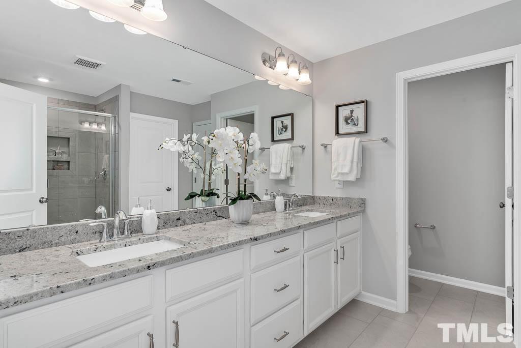 112 Thrower Lane Garner, NC 27529 - Photo 24 of 38 a bathroom with double sink and a mirror