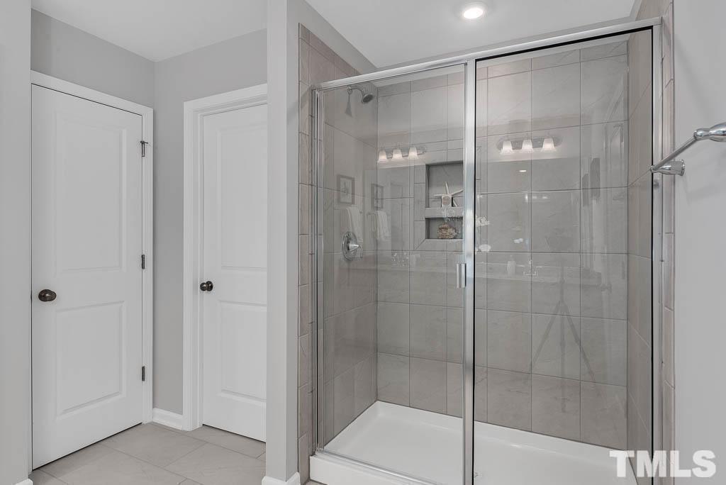 112 Thrower Lane Garner, NC 27529 - Photo 25 of 38 a bathroom that has a glass shower door