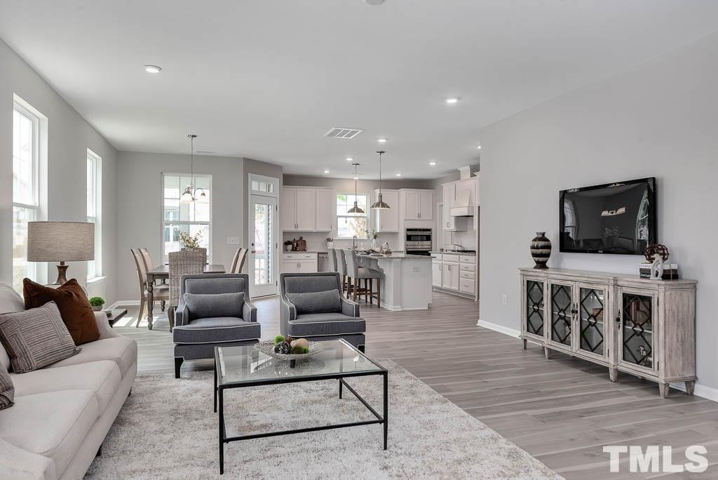 112 Thrower Lane Garner, NC 27529 - Photo 7 of 38 a living room with furniture and a flat screen tv