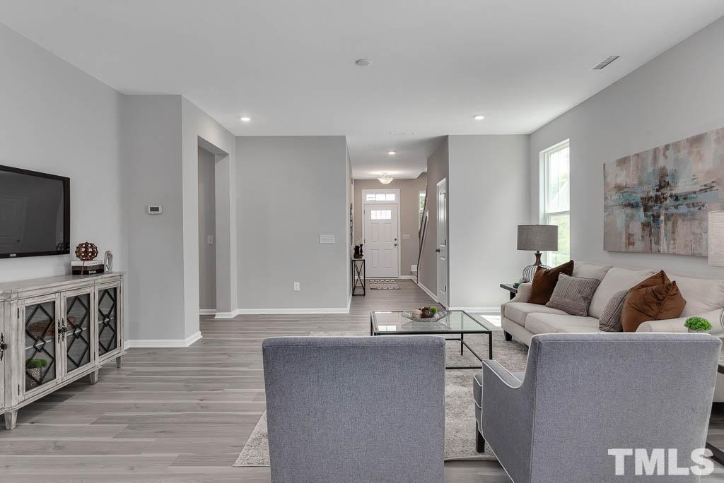 112 Thrower Lane Garner, NC 27529 - Photo 8 of 38 a living room with furniture and a flat screen tv