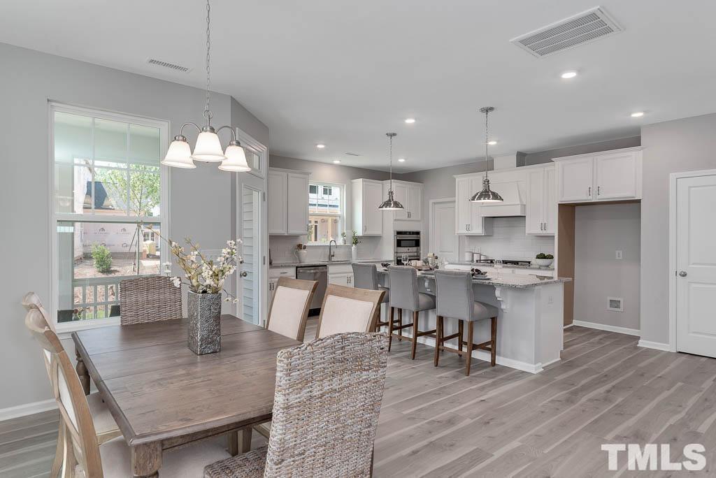 112 Thrower Lane Garner, NC 27529 - Photo 9 of 38 a large kitchen with a table and chairs