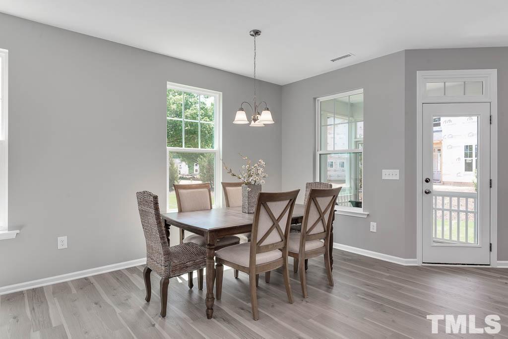 112 Thrower Lane Garner, NC 27529 - Photo 10 of 38 a view of a dining room with furniture and wooden floor