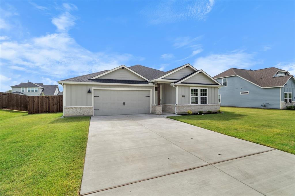623 Kyle Drive Tioga, TX 76271 - Photo 2 of 40 a front view of a house with a garden and yard