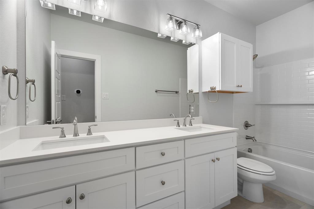 623 Kyle Drive Tioga, TX 76271 - Photo 30 of 40 a bathroom with a toilet a sink and mirror