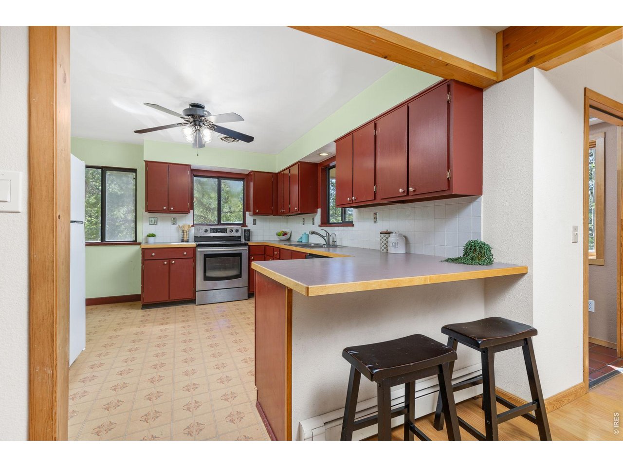 414 Upper Travis Gulch Road Black Hawk, CO 80422 - Photo 14 of 50 a kitchen with kitchen island a sink table and chairs