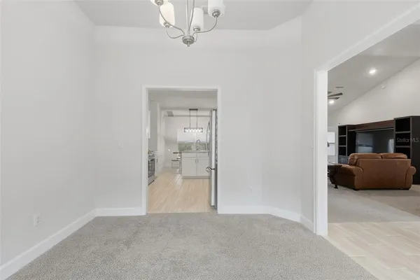 a spacious bedroom with a bed a couch and a window